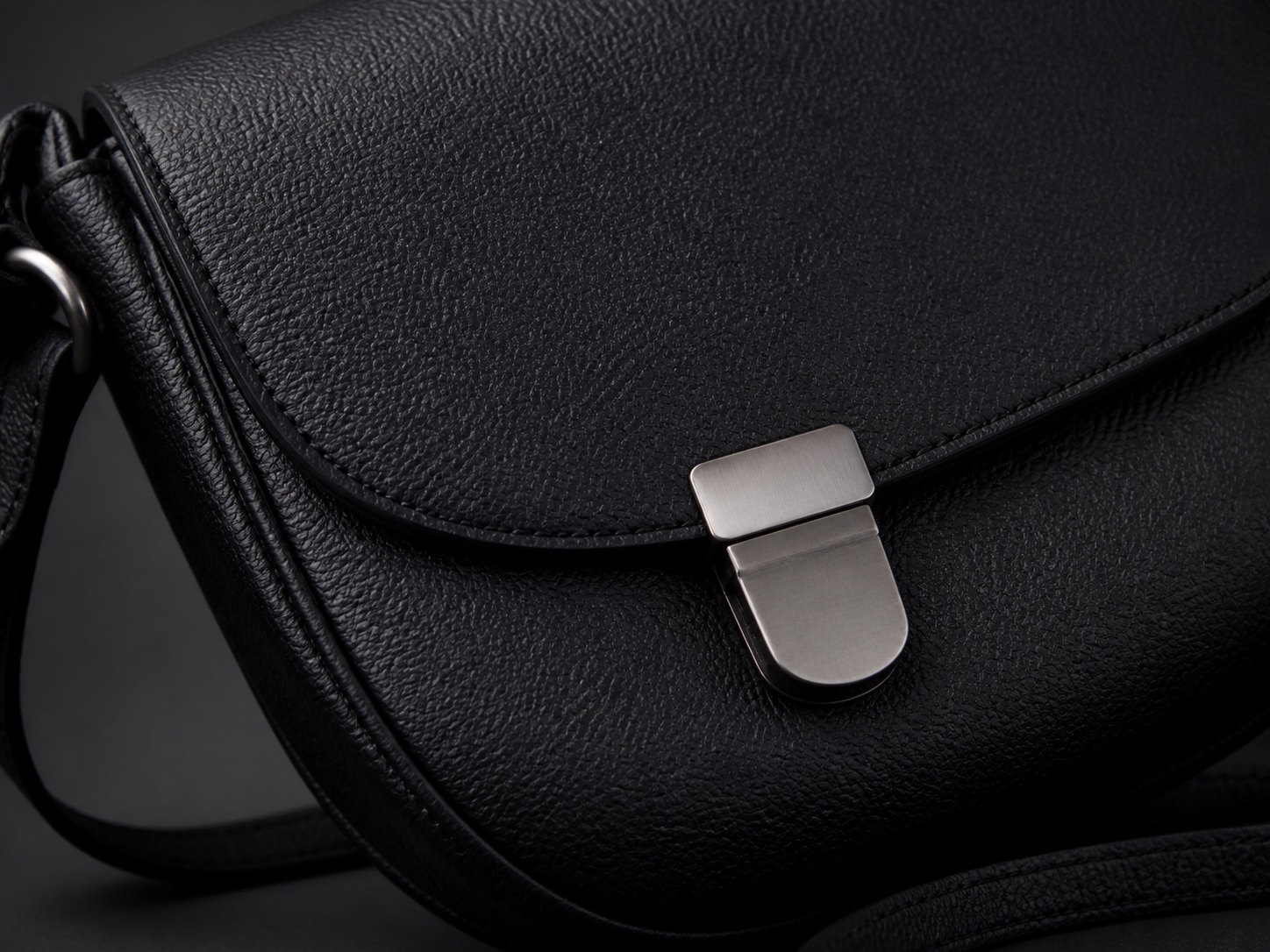 Close-up example showing the surface and stitching of a black leather bag